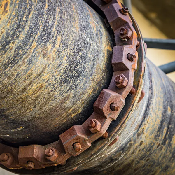 Corroded cast iron pipe flange with rusted bolts