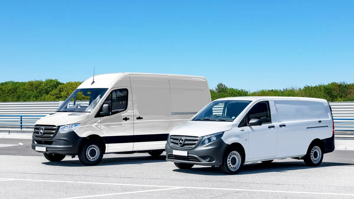 Two clean white service vans parked in a lot