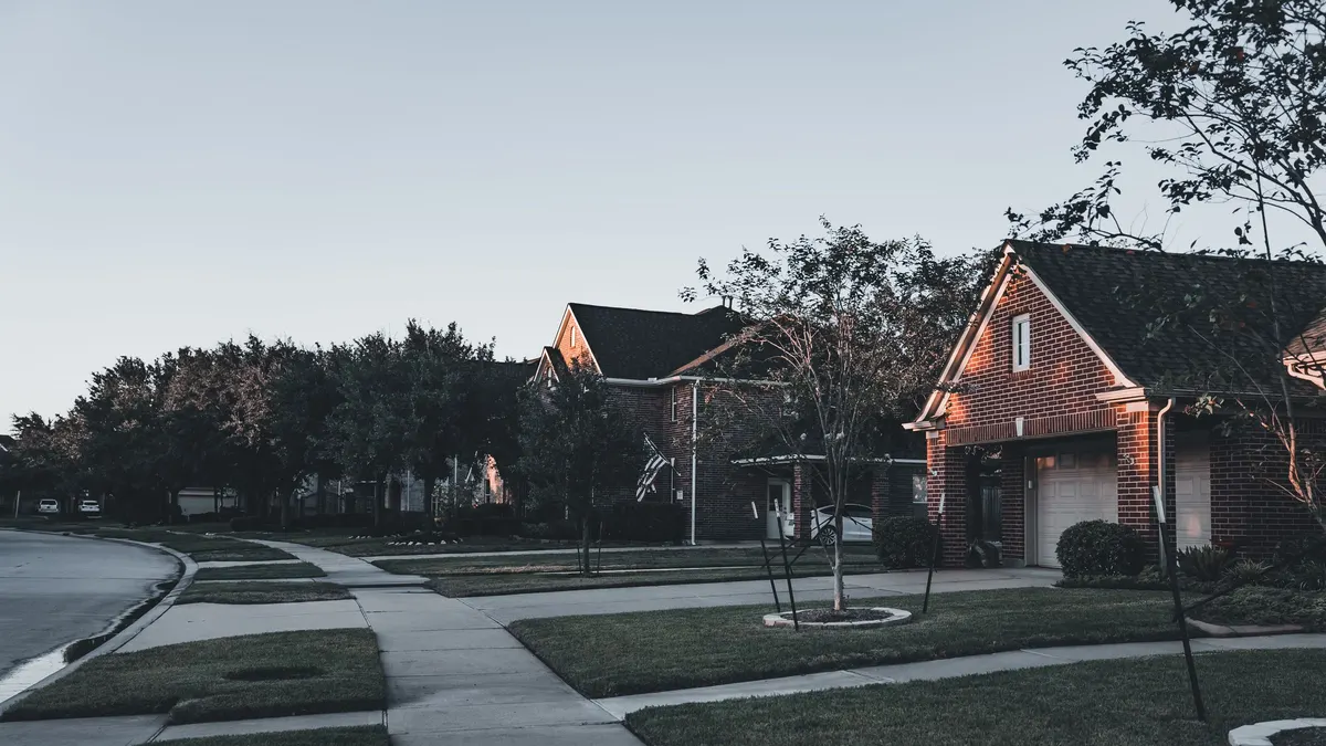 Brick houses on a quiet residential street with mature trees