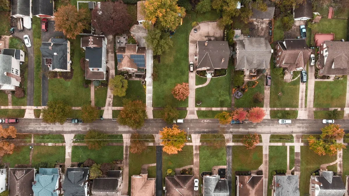 Aerial view of an older neighborhood with tree-lined streets in autumn